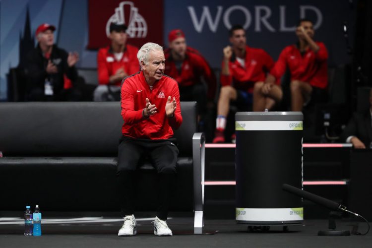 Team World captain John McEnroe exhorts his players to victory assisted by his younger brother, Patrick on the bench. 