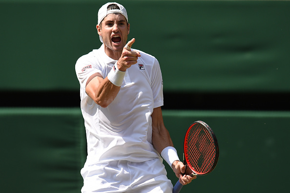John Isner celebrates winning the second set against South Africa's Kevin Anderson during their men's singles semi-final match on the eleventh day of the 2018 Wimbledon Championships at The All England Lawn Tennis Club in Wimbledon, southwest London, on July 13, 2018.