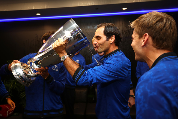Roger Federer initiates celebrations as he takes the first gulp of champagne post winning the Laver Cup in Chicago. Photo: Clive Brunskill/Getty Images