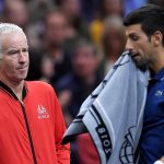 Sorry pal: John McEnroe keeps uncharacteristically tight-lipped as Novak Djokovic crosses his path. Photo: Clive Brunskill/Getty Images