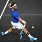 Fabio Fognini stretches to play a forehand in his singles match against Jack Sock