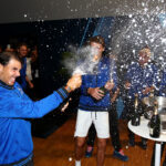 Rafael Nadal cracks open a bottle of champagne in the locker-room