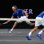 Alexander Zverev and Roger Federer swap sides during their doubles on Friday night
