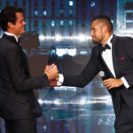 Nick Kyrgios welcomes Milos Raonic to the stage at the Laver Cup Gala on Thursday