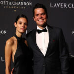 Milos Raonic poses on the black carpet with friend Camille Ringoir