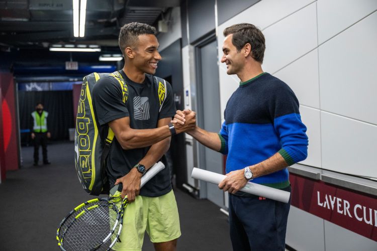 Felix Auger Aliassime and Roger Federer greet each other at Rogers Arena