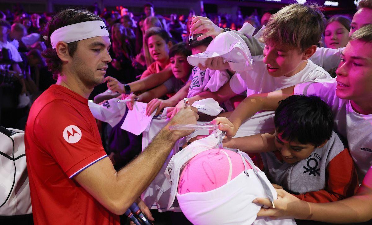 Taylor Fritz of Team World signs tennis balls during Open Practice. Photo by Maja Hitij/Getty Images