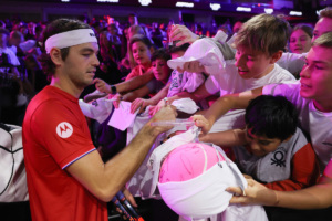 Taylor Fritz of Team World signs tennis balls during Open Practice. Photo by Maja Hitij/Getty Images