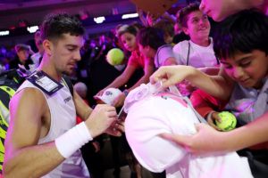 Thanasi Kokkinakis of Team World signs autographs. Photo by Maja Hitij/Getty Images