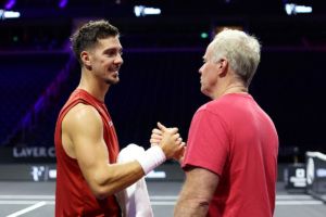 Thanasi Kokkinakis of Team World shakes hands with Patrick McEnroe, Vice-Captain of Team World. Photo by Maja Hitij/Getty Images