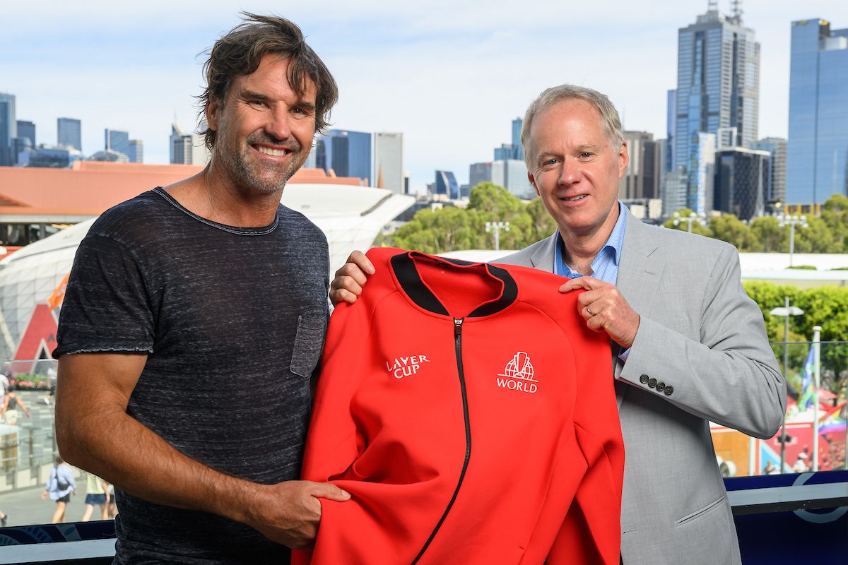 Pat Rafter accepts the Team World red jacket from out-going Vice Captain Patrick McEnroe in Melbourne during Australian Open 2025. 