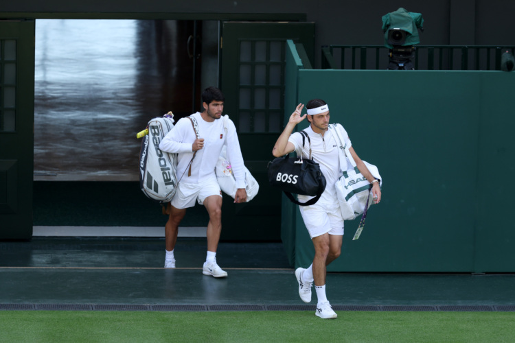 Taylor Fritz leads Carlos Alcaraz out onto Center Court for their Wimbledon semifinal, which the Spaniard won in four sets. 