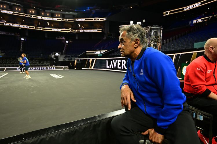 Team Europe Captain Yannick Noah keeps an eye on practice at his first media call on center court. 