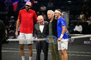 Legends Rod Laver and John McEnroe at the first match coin toss.
