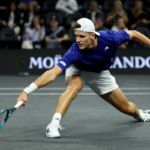 Mensik reaches for a low backhand.