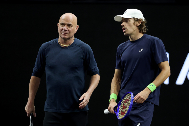 Team World captain Andre Agassi spends time with Australian teammate Alex de Minaur. 