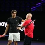 A quiet word: Agassi hears from Taylor Fritz.