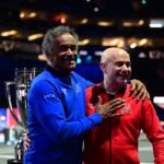 Yannick Noah greets Team World captain Andre Agassi.