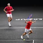 De Minaur in full flight, watched by partner Fritz.