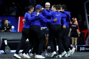 Team Europe players and captains get around Zverev.
