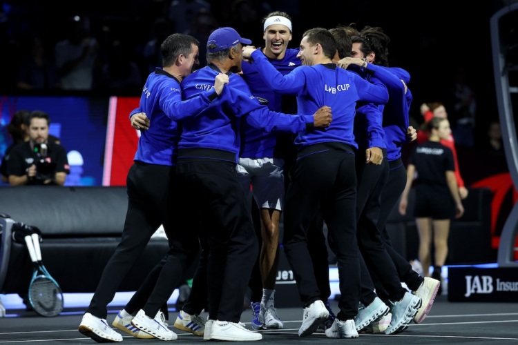 Team Europe players and captains get around Zverev.